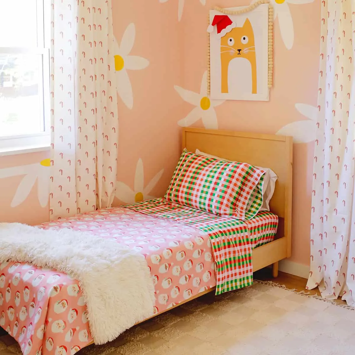 Kid&#x27;s room decorated for the holidays with Christmas sheets and curtains