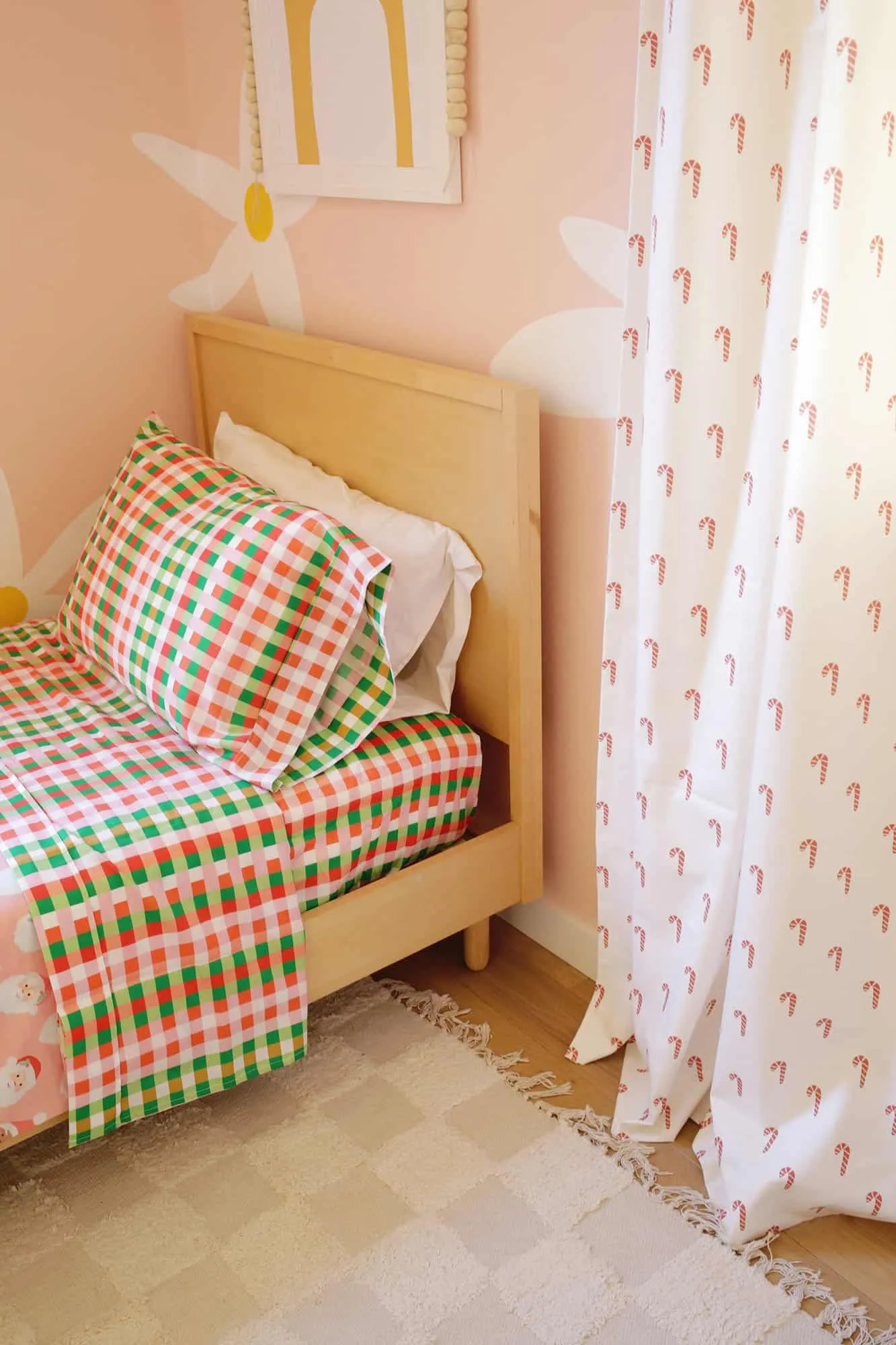 Kid&#x27;s room decorated for the holidays with Christmas sheets and curtains