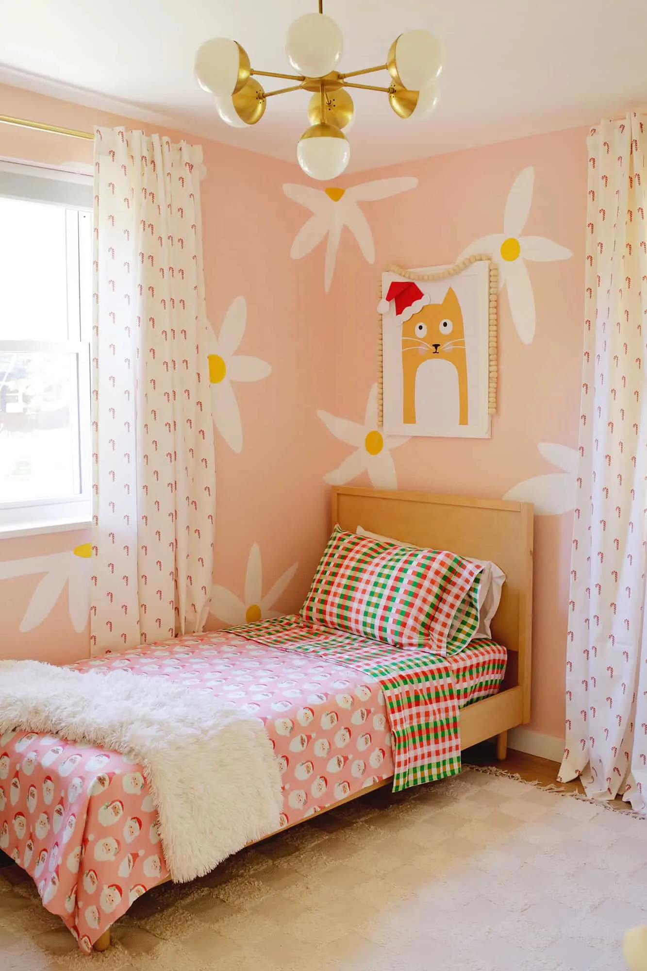 Kid&#x27;s room decorated for the holidays with Christmas sheets and curtains