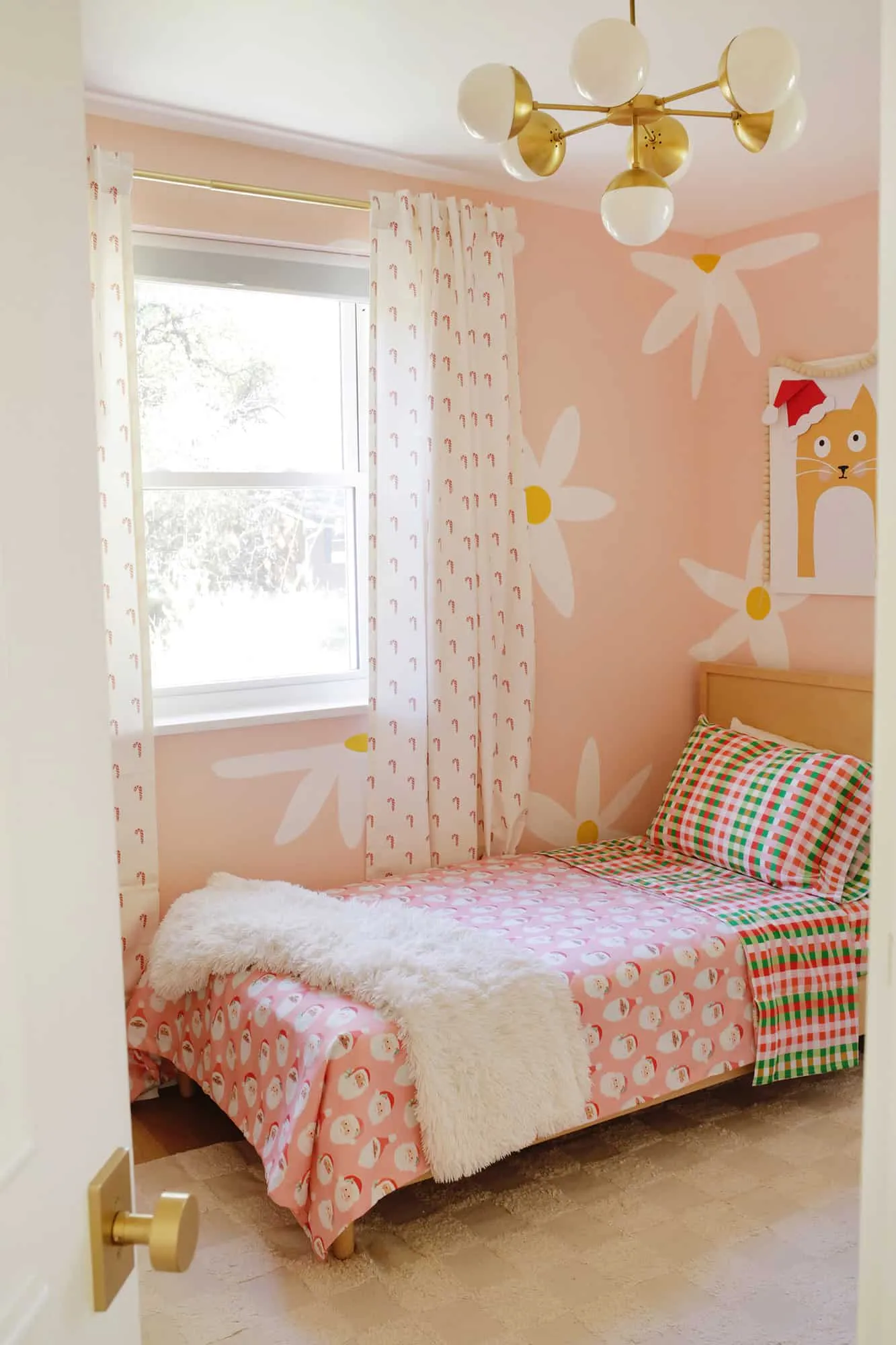 Kid&#x27;s room decorated for the holidays with Christmas sheets and curtains