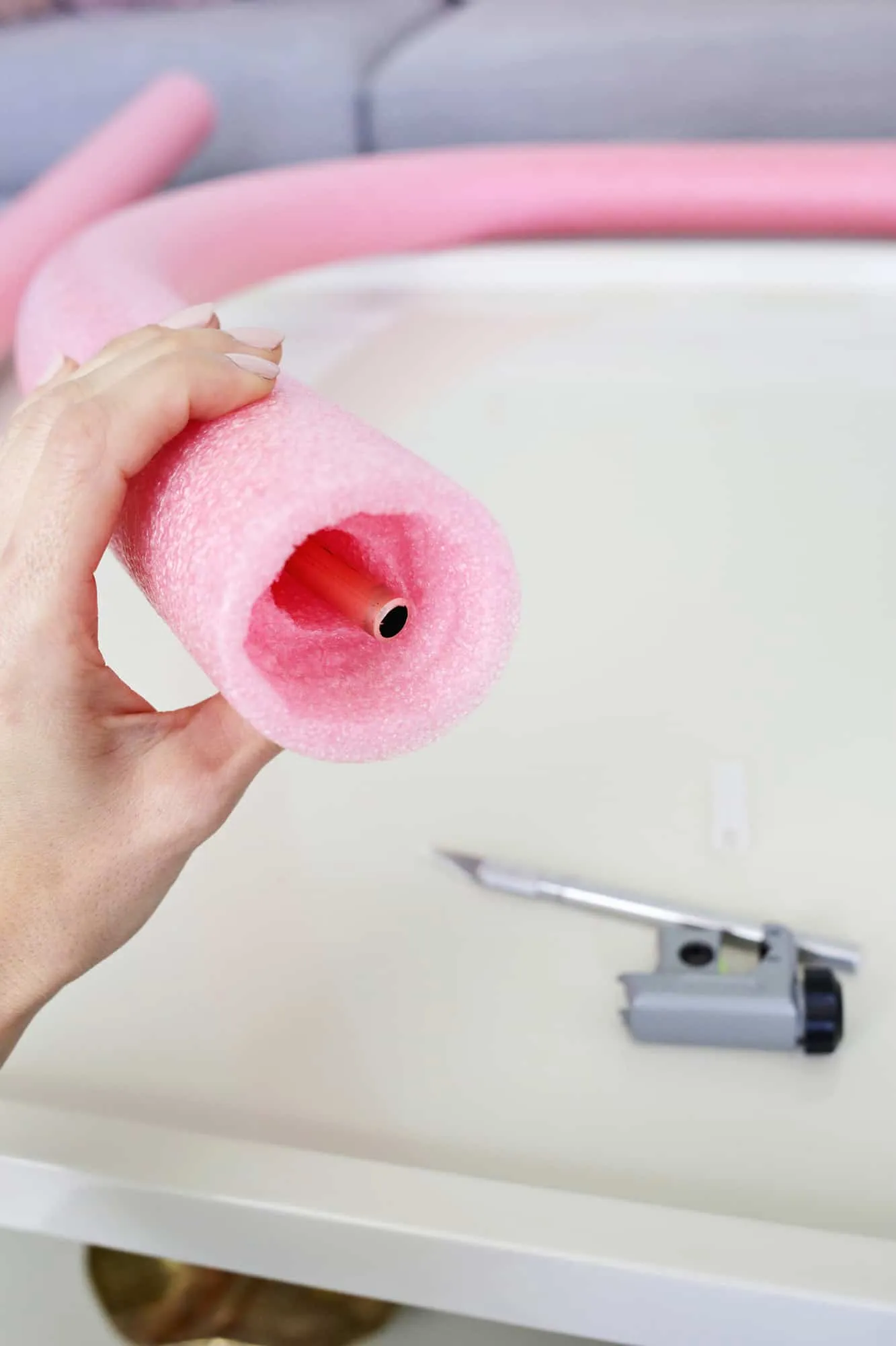 Copper tubing inside a pink pool noodle