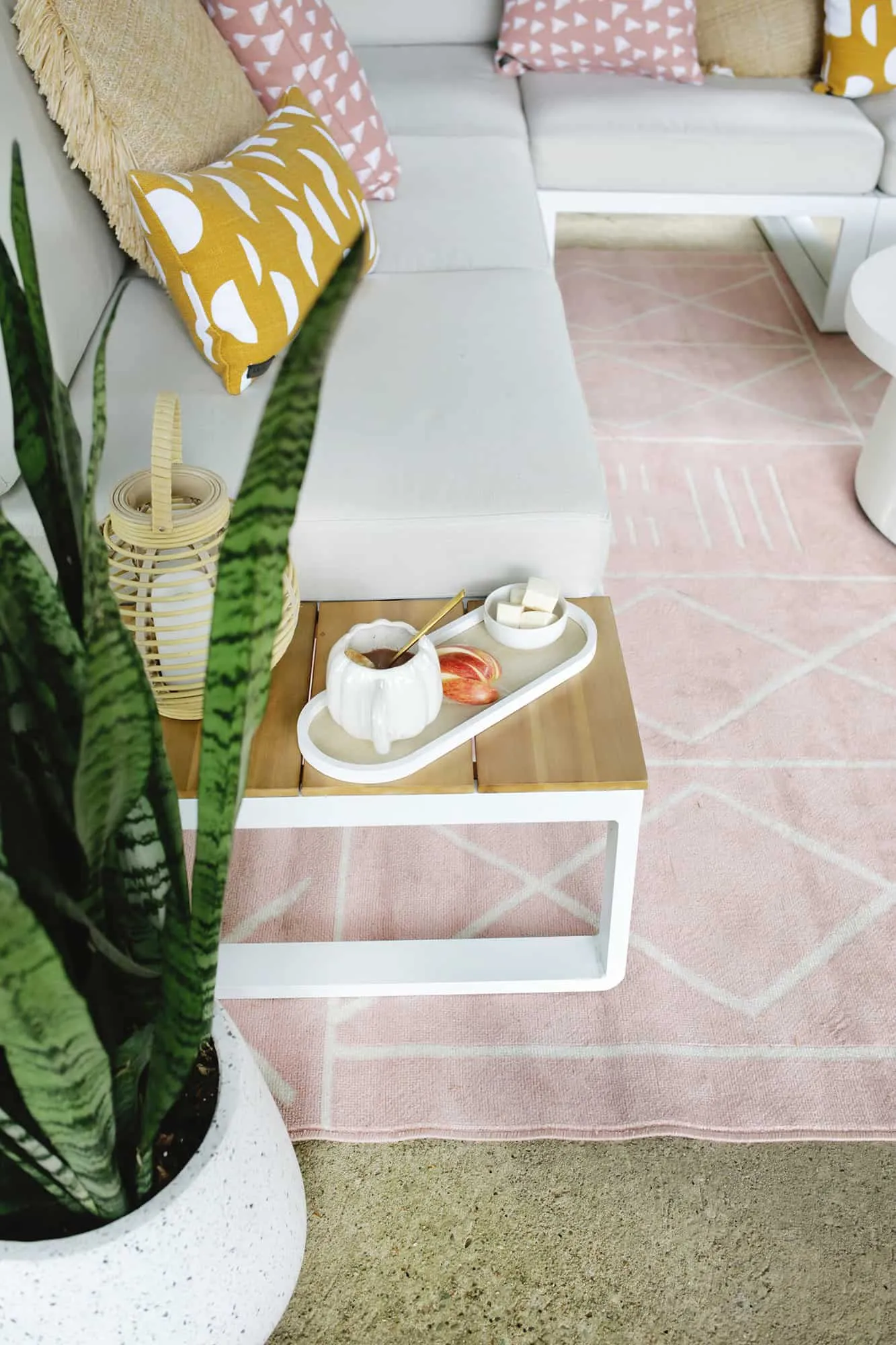 Hot chocolate and snack on the side table of an outdoor couch